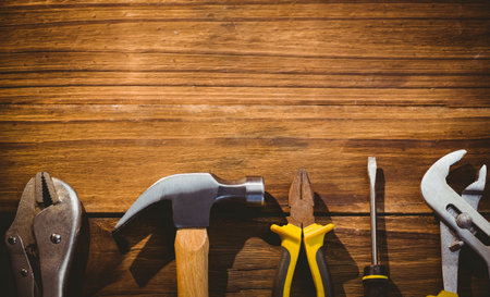 Hammer with wooden handle is resting on rustic plank bench in flat design workshop illustration. Hardware, craftsmanship, woodworking, repair, construction, industrial, diyの写真素材