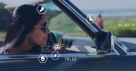 Driving woman wearing aviator sunglasses cruising convertible on coastal road, AR icons, copy space. Adventure, exploration, technology, innovation, mobility, outdoor, leisureの写真素材