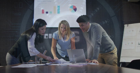 Leaning professionals analyzing online sales data at conference room, with laptop and charts....