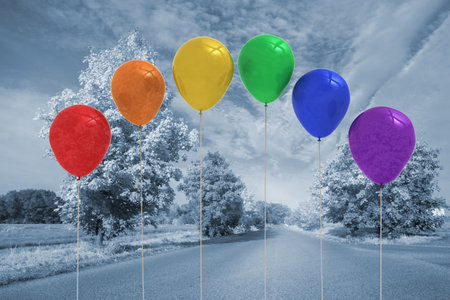 Six colorful balloons are floating across road flanked by trees under cloudy sky in flat design. Vibrant, celebration, freedom, serenity, landscape, outdoor, whimsicalの写真素材