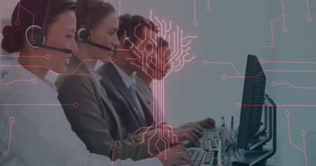 Handling calls using headsets and typing on computers at office desk under digital circuit overlay....