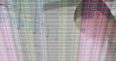 Monitoring analyst in dark blazer viewing LED stock ticker in office showing red green numbers....