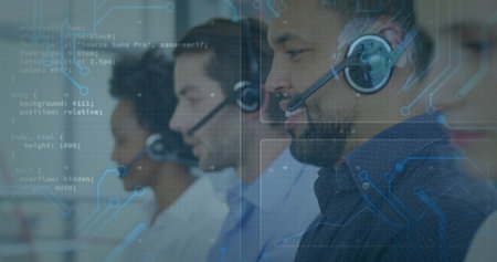 Call center agent in patterned shirt handling calls in office, headsets and monitors, copy space. Technology, communication, teamwork, professional, corporate, modern, collaborativeの写真素材