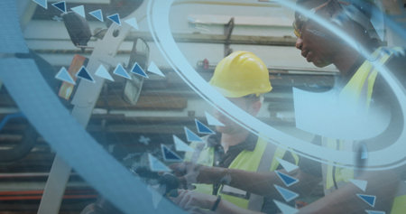 Inspecting men wearing yellow hard hats examining control panel in plant, with interface overlay....