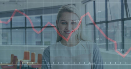 Standing professional in blazer showing data in modern office with grid windows, red graph overlay. Corporate, technology, modern, analytics, productivity, business, workspaceの写真素材