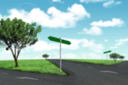 View of tree on field by forked road against skyの写真素材