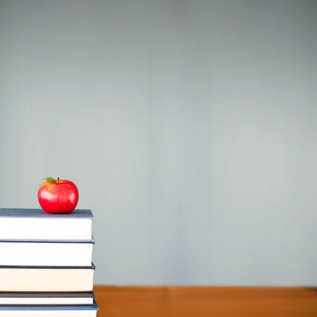 Red apple on pile of books in classroomの写真素材