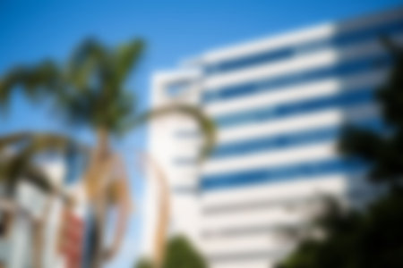 Low angle view of modern buildings against blue sky in cityの写真素材
