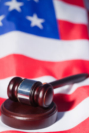 Close-up of brown gavel on American flagの写真素材