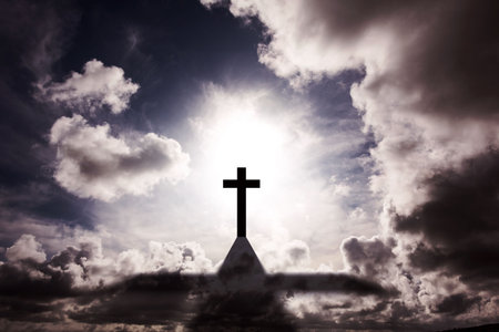 Silhouetted cross is glowing above roof peak with sun halo against swirling clouds in flat design. Spiritual, religious, silhouette, dramatic, celestial, minimalist, worshipの写真素材