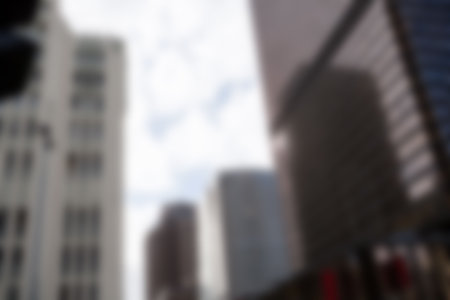 Modern buildings against cloudy sky in cityの写真素材