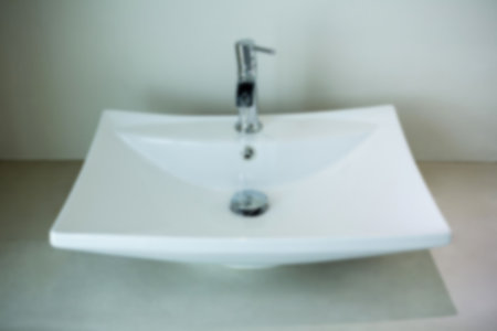 High angle view of water running from faucet in wash basinの写真素材