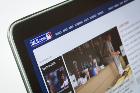 Major League Baseball webpage on tablet screen against white background