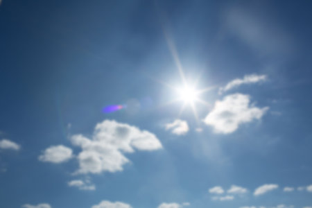 Low angle view of sunbeams with lens flare during sunny dayの写真素材