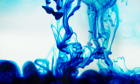 Blue ink spreading in the waterの写真素材