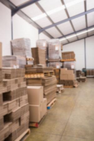 Stack of cardboard boxes against wall in storage room