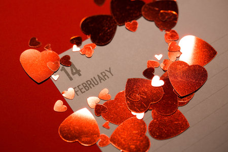 Digital image of hearts on paper with date against red backgroundの写真素材