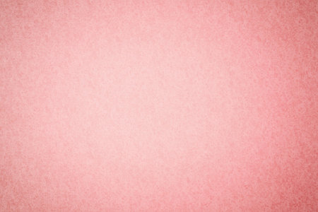 Textured pastel pink surface filling frame in flat design with fine grain texture, copy space....