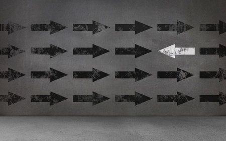 Black and white arrows on concrete wallの写真素材