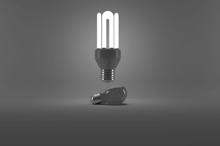 Digital image of illuminated energy efficient lightbulb over bulb on gray backgroundの写真素材
