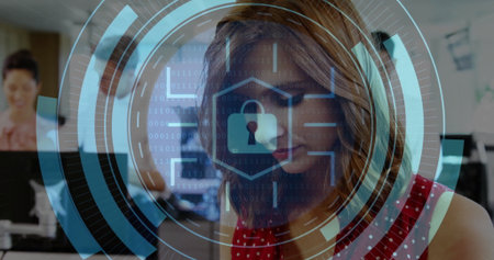 Working woman wearing red polka-dotted dress typing on keyboard at open office, with lock interface. Collaboration, technology, professional, teamwork, modern, productivity, securityの写真素材