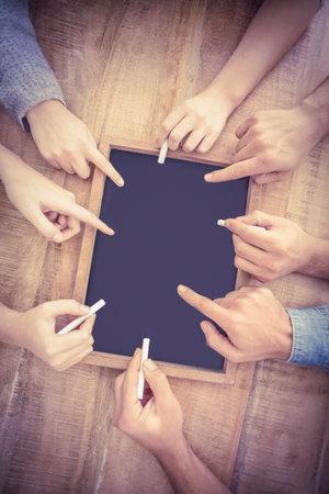 Hands writing on chalkboardの写真素材