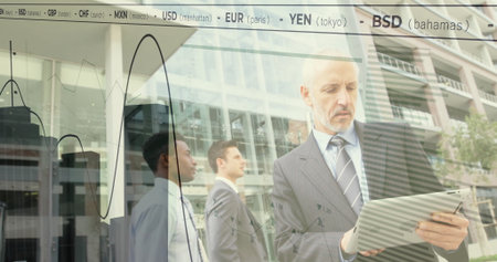 Analyzing financial graphs suit-wearing executive holding tablet in plaza with ticker, copy space. Corporate, finance, technology, modern, professional, urban, dataの写真素材