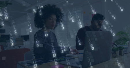 Binary code image over diverse people working on laptops in office. Technology, digital, teamwork, collaboration, innovation, codingの写真素材