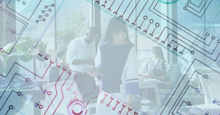 Circuit pattern image over diverse professionals working in modern office. Technology, innovation,...