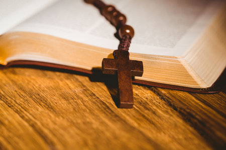 Rosary beads on open bible pagesの写真素材