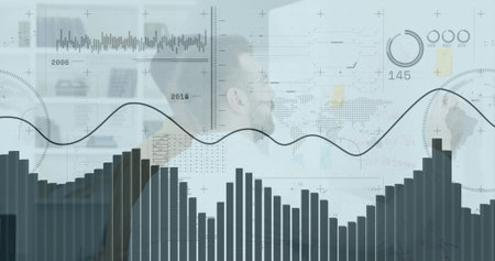 Analyzing financial graphs, businessman in office using laptop and data charts. Finance, analytics,...