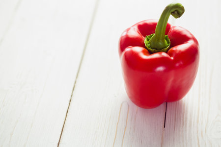 Close-up of fresh red pepper on wooden tableの写真素材