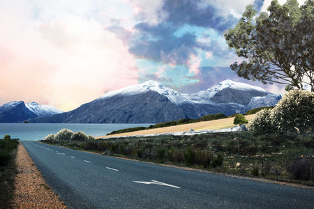 Paved two-lane road is stretching toward snow-capped mountains with lake, tree in flat design. Scenery, landscape, travel, adventure, serenity, nature, explorationの写真素材