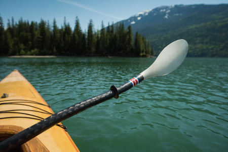Oar in kayak over lake against mountain