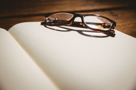 Close-up of eyeglasses at deskの写真素材