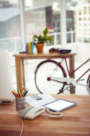 Land line phone and digital tablet on desk in officeの写真素材