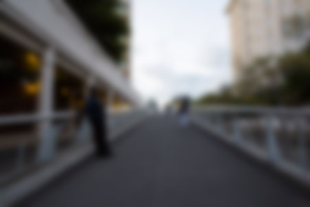 Person standing on footbridge in city