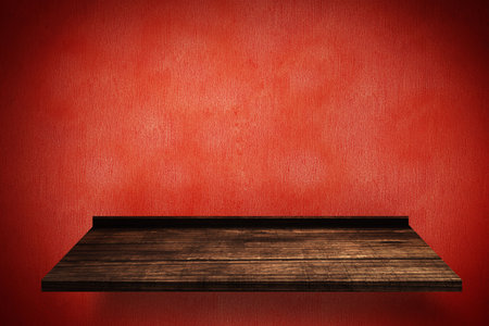 Composite image of wooden shelf on red wallの写真素材