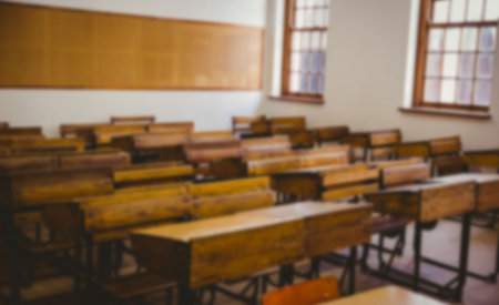 Chairs and tables arranged in classroom at universityの写真素材