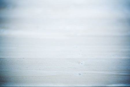 Flat design is showing light wooden tabletop surface featuring subtle grain lines and soft blur. Minimalist, natural, organic, texture, neutral, elegance, simplicityの写真素材