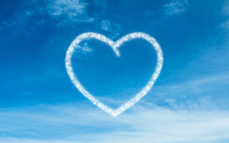 Flat design showing bright blue sky forming heart-shaped cloud amid wispy cloud streaks. Heavens,...
