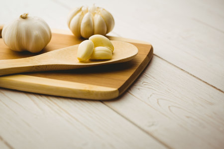 High angle view of garlic cloves and bulb on chopping boardの写真素材