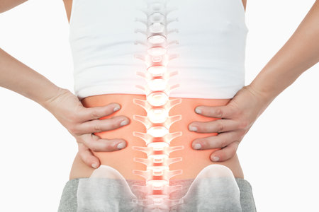 Digital composite of highlighted spine of woman with back pain