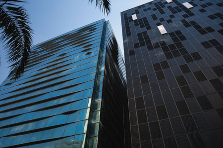 Low angle view of tree and building against blue skys