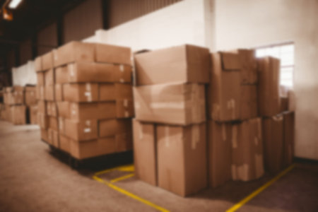 Piles of cardboard boxes in storage room of warehouse