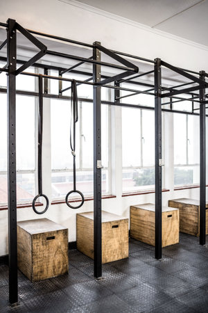 Gymnastics rings by window at gym