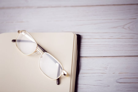 Close-up of eyeglasses on textured wooden table