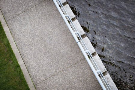 High angle view of empty footpath by lake