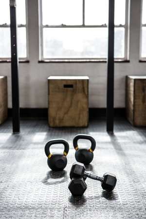 General view of gym with dumbbells on floor, boxes and window. Sport, lifestyle and healthcare concept.の写真素材