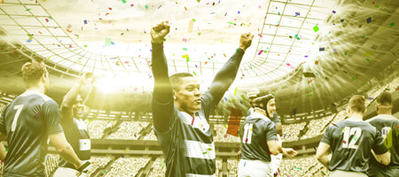 Multiracial male players with arms raised standing with team in stadium. Sport, teamwork, winning,...
